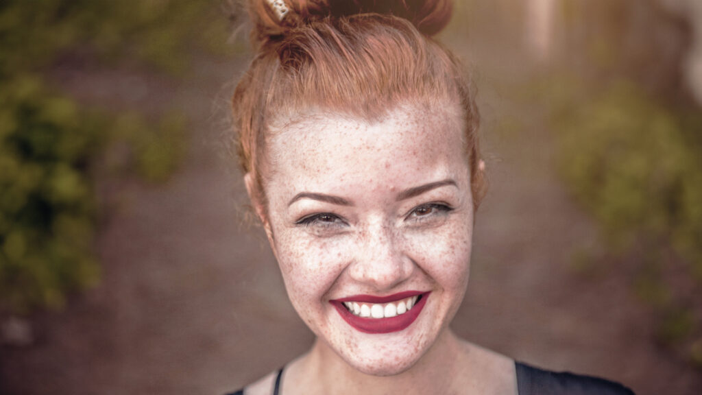 Woman's face showing skin with freckles, skin type, skin care, young skin