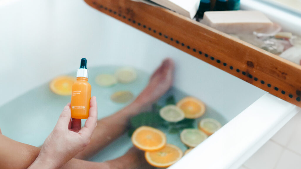 Vitamin C serum bottle being used in the bath