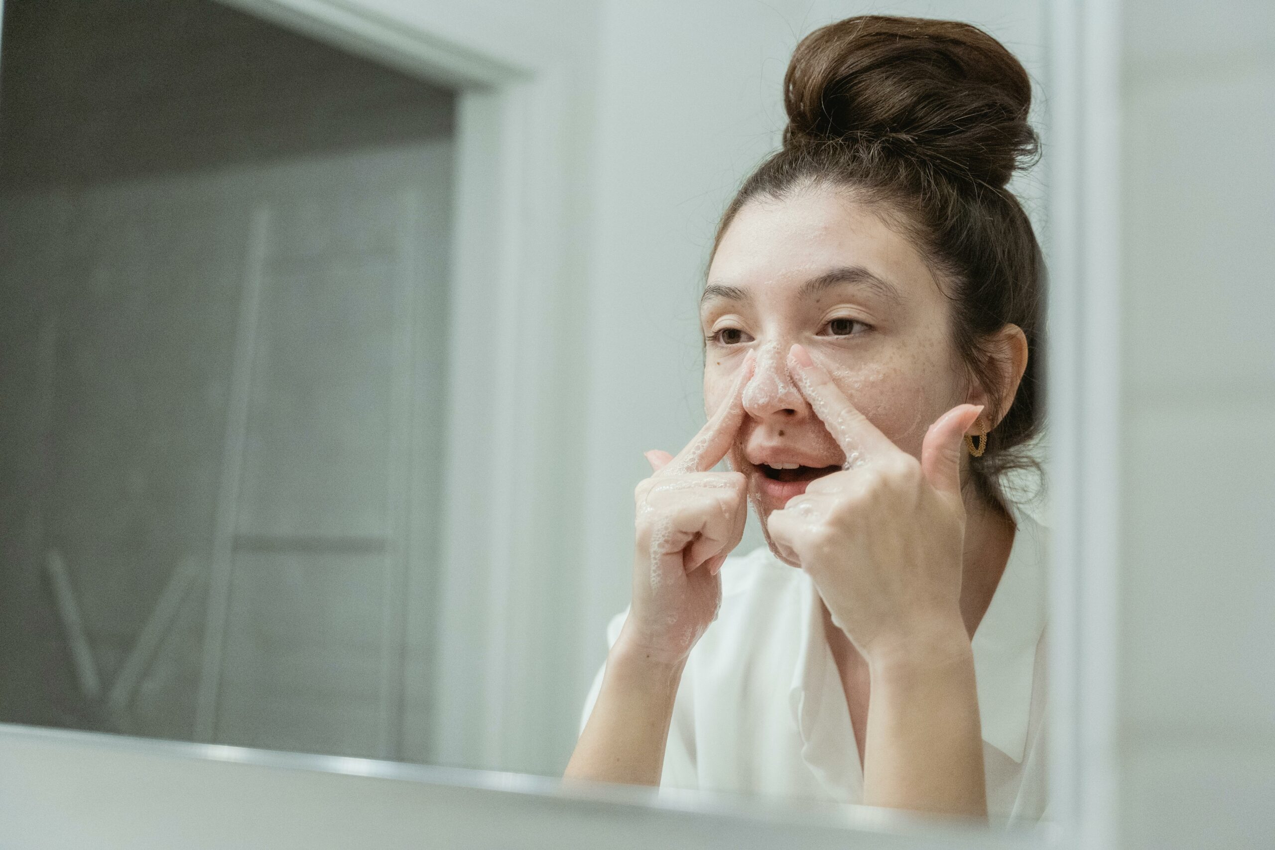 Image of a woman cleaning skin with a streamlined and minimalist approach. Skin streaming concept.